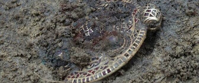 A student in Norfolk never expected that his discovery of a female skeleton wearing a pendant could rewrite Anglo-Saxon history – but researchers say that the "exquisite" piece of gold is doing just that.